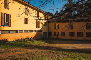 a person sitting on a bench in front of a building at Debre Mariam Guest House in Bologna
