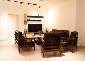 a living room with a table and chairs and a television at Casa de Simoncis in Batroûn