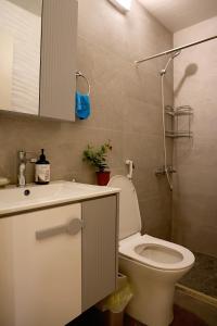 a bathroom with a toilet and a sink and a shower at Casa de Simoncis in Batroûn +20 photos