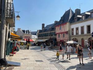 a group of people walking down a city street at Gite Gavotte in Concarneau