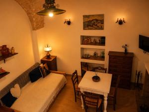 a living room with a couch and a table at Dimora dei Ciri in Ferrandina +4 photos