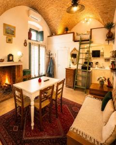 a living room with a table and a fireplace at Dimora dei Ciri in Ferrandina