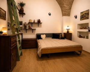 a room with a bed in a room with shelves at Dimora dei Ciri in Ferrandina