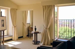 a living room with large windows and a balcony at Villa Florentine, A Beauvallon Hotel & Spa in Lyon +126 photos
