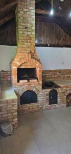 a large brick fireplace in a room with at Casa Chișcău - Valea Urșilor in Chişcău +3 photos