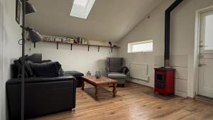 a living room with a couch and a wood stove at Snaefell Apartments in Hellissandur