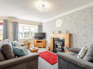 a living room with two couches and a fireplace at 1 Bed in Conwy oc-79357 in Llangelynin