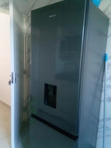 a stainless steel refrigerator in a room at Flora House in Maputo