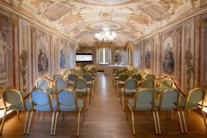 a room with chairs and paintings on the walls at Posta Donini 1579 - UNA Esperienze in San Martino in Campo +139 photos