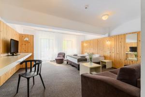 a hotel room with two beds and a television at Complex Hotelier COTA O MIE in Sinaia