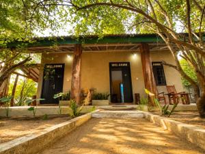 a building with trees in front of it at Ela Addara Green Villa in Sigiriya