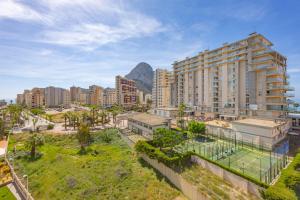 an aerial view of a city with buildings and a mountain at Apartamento Larimar - PlusHolidays in Ifach