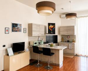 a kitchen with a large island with chairs in it at iDream Apartment & Rooms in Catania