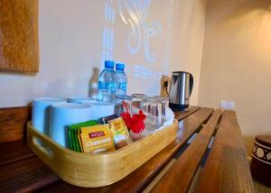 a wooden tray with drinks on a table at Ocean Breeze Boutique Hotel in Nungwi