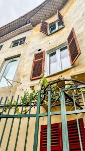 a building with windows and a green fence at Moon's House Oropa in Biella