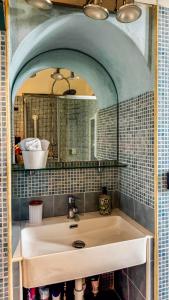a bathroom with a sink and a mirror at Moon's House Oropa in Biella +31 photos