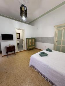 a bedroom with a bed and a table and a mirror at Atelier Peretti in Alghero