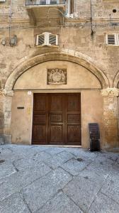 a building with a large wooden garage door at Atelier Peretti in Alghero +10 photos