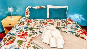 a bed with two towels and pillows on it at Moon's House Oropa in Biella