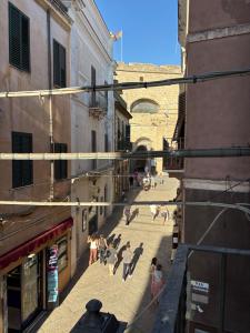 a group of people walking down a street at Atelier Peretti in Alghero