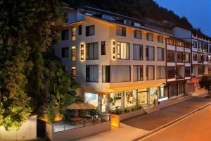an exterior view of a hotel at night at Mountain Luxury Courtyard Hotel-Zhangjiajie Wulingyuan National Forest Park-Laundry Service,coffee&Chinese Tea--Free airportpick-up or drop-off for Reserve of 4nights or more in Zhangjiajie