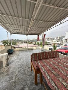 a bed on a patio with a large canopy at Yalçın Pansiyon in Silifke