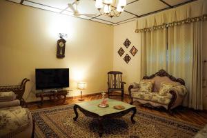 a living room with a couch and a coffee table at Vaani Greens Wildlife Resort, Kaziranga in Kuthari
