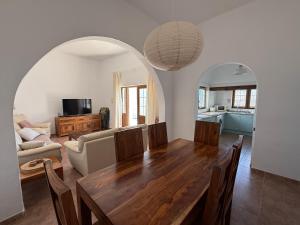 a dining room with a table and a living room at Villa Ann Lanzarote in Nazaret