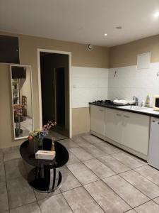 a kitchen with a counter and a table in it at T1 Meublé in Saint-Chamond