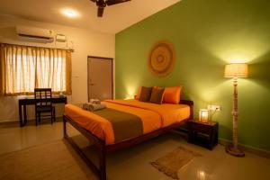 a bedroom with a bed and a desk with a lamp at Seraya Stays in Mandrem