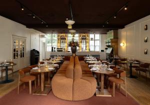 a large dining room with tables and chairs at Hotel Kasteel Doenrade in Doenrade