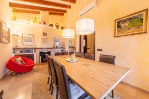 a dining room with a wooden table and chairs at Villa Calvario by Sealand Villas in Pollença