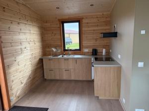 a kitchen with a sink and a window in a cabin at Lighthouse-Inn in Gardur +77 photos