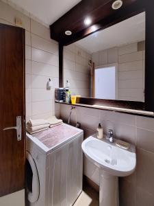 a bathroom with a sink and a mirror at Apartman Pasic in Sarajevo +12 photos