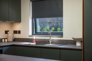 a kitchen with a sink and a window at Retreat 1 in Beccles