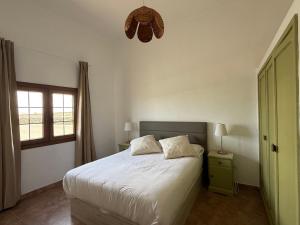 a bedroom with a white bed and a window at Villa Ann Lanzarote in Nazaret