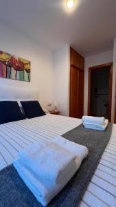 a bedroom with a large bed with two towels on it at V.U.T. EL HONGO in Mora de Rubielos