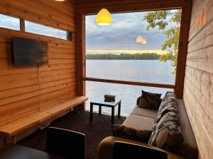 a living room with a view of a lake at Kyly in Savonlinna