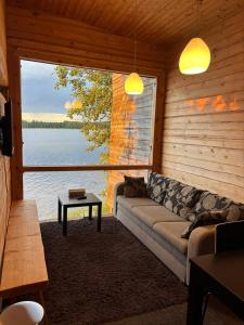 a living room with a couch and a large window at Kyly in Savonlinna