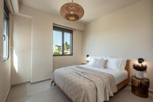 a white bedroom with a bed and a window at Villa Terra Rossa in Daratso +53 photos
