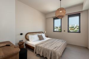a bedroom with a bed and two windows at Villa Terra Rossa in Daratso