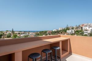 a bar on the balcony of a building with stools at Villa Terra Rossa in Daratso