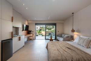 a bedroom with a large bed and a living room at Villa Terra Rossa in Daratso