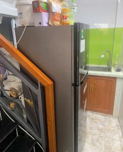 a refrigerator in a kitchen next to a sink at eStay in Ho Chi Minh City