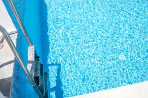 a close up of a blue swimming pool at Casa Evita in Gennadi