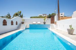 a swimming pool in a villa with blue water at Casa Evita in Gennadi