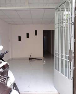 an empty room with a gate and a motorcycle in it at eStay in Ho Chi Minh City