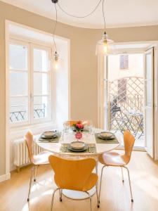 a dining room with a white table and chairs at The Secret Lakeside in Gravedona +24 photos