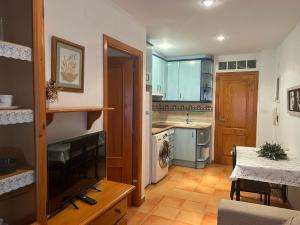 a kitchen with a sink and a table in a room at V.U.T. EL HONGO in Mora de Rubielos