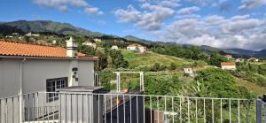 a balcony of a house with mountains in the background at A Casa de Santana in Santana